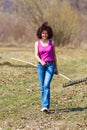 Young woman with a rake in an orchard Royalty Free Stock Photo