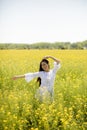 Young woman in the rapeseed field