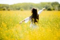 Young woman in the rapeseed field