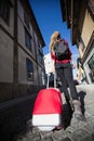 Young woman raveler walking in old european town