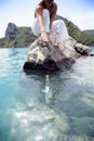 Young woman reaching for a message in a bottle