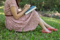 Young woman reading bible in natural park Royalty Free Stock Photo