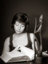 Young woman reading big book, concentration and attentiveness