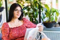 Young woman reading book at cafe near window Royalty Free Stock Photo