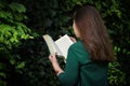 Young Woman Reading Book In The Forest