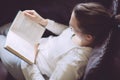 Young woman reading book at home Royalty Free Stock Photo