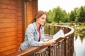 Young woman reading book outdoors Royalty Free Stock Photo