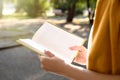 Young woman reading book outdoors, closeup view Royalty Free Stock Photo