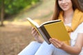 Young woman reading book outdoors, closeup view Royalty Free Stock Photo