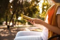 Young woman reading book outdoors, closeup view Royalty Free Stock Photo