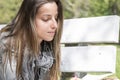 Young woman reading a book on a park bench Royalty Free Stock Photo
