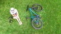 Young woman reading book in park near bike. Student girl relaxing outdoors sitting on grass with bicycle Royalty Free Stock Photo