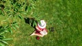 Young woman reading book in park, student girl relaxing outdoors sitting on grass with book and headphones, aerial drone view Royalty Free Stock Photo