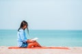 Young person reading book during tropical white beach Royalty Free Stock Photo