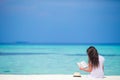 Young woman reading book during tropical white Royalty Free Stock Photo