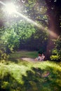 Young woman reading a book under the tree Royalty Free Stock Photo