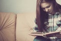 Young woman reading. Close up on woman hands turning page in vintage book. Woman read a book. Soft photo of female hands Royalty Free Stock Photo