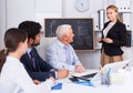 Young woman is reading financial report to colleagues on meeting Royalty Free Stock Photo