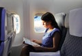 Young woman reading magazine during the flight Royalty Free Stock Photo