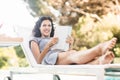 Young woman reading magazine near poolside Royalty Free Stock Photo