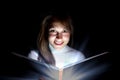 Young woman reading a magic book Royalty Free Stock Photo