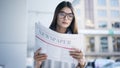 Young woman reading newspaper in outdoors Royalty Free Stock Photo