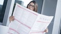 Young woman reading newspaper in outdoors Royalty Free Stock Photo