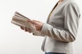 Young woman reading newspaper on white background Royalty Free Stock Photo