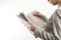 Young woman reading newspaper on white background Royalty Free Stock Photo