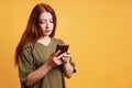 young woman reading text message on smartphone or mobile cell phone Royalty Free Stock Photo