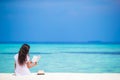 Young woman reading on tropical white beach Royalty Free Stock Photo