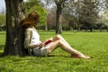 Young woman reading under a tree Royalty Free Stock Photo