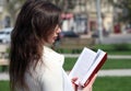 Young woman reads book