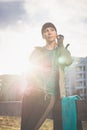 Young woman ready for outdoor workout listening to music through Royalty Free Stock Photo