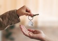 Young woman received house keys from real estate agent