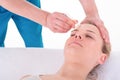 Young Woman receives facial cupping massage facial rejuvenation treatment at acupuncture wellness spa Royalty Free Stock Photo