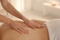Young woman receiving back massage in spa salon Royalty Free Stock Photo