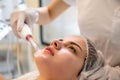 Young woman receiving electric darsonval facial massage treatment at beauty salon. Royalty Free Stock Photo