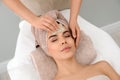 Young woman receiving facial massage with gua sha tool in salon Royalty Free Stock Photo