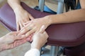 Young woman receiving hand massage in spa salon by professional masseuse Royalty Free Stock Photo