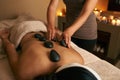 Restoring her balance. A young woman receiving hot stone therapy at the spa. Royalty Free Stock Photo