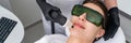 Young woman receiving laser treatment in cosmetology clinic