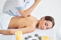 Young woman receiving relaxing back massage by professional therapist at spa salon Royalty Free Stock Photo