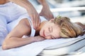 Enjoying a great massage. Young woman receiving a relaxing massage. Royalty Free Stock Photo