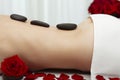 Young Woman Receiving Warm Stone Massage Red Roses Royalty Free Stock Photo