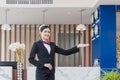 Young woman receptionist standing and smiling at the front desk of the hotel reception, Portrait of Female receptionist working in Royalty Free Stock Photo