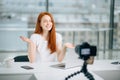 Young woman recording video on camera mounted on tripod for her vlog Royalty Free Stock Photo