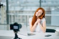 Young woman recording video on camera mounted on tripod for her vlog Royalty Free Stock Photo