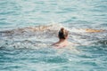 Young woman in red bikini on Beach. Happy lady in bathing suit chilling and sunbathing by turquoise sea ocean on hot Royalty Free Stock Photo