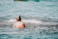 Young woman in red bikini on Beach. Happy lady in bathing suit chilling and sunbathing by turquoise sea ocean on hot Royalty Free Stock Photo